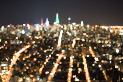 Defocused image of illuminated city at night