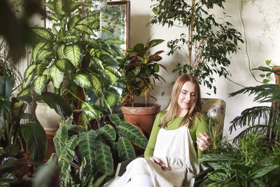 Portrait of woman against plants