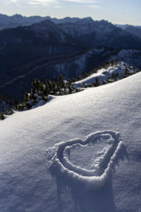 Heart shape on snow covered land