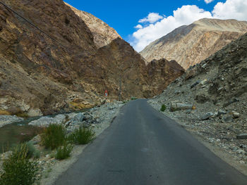 Road amidst mountains against sky