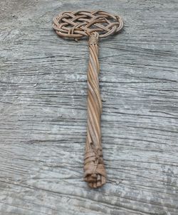 The mattress beater made of woven rattan wood  shot on the cement floor above the house building