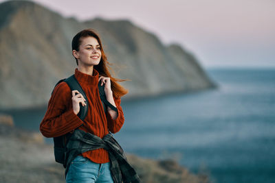 Portrait of young woman standing on beach