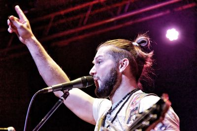 Low angle view of guitarist performing in concert