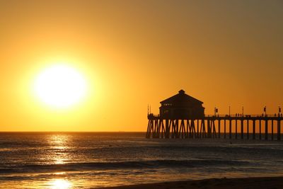 Scenic view of sea against orange sky