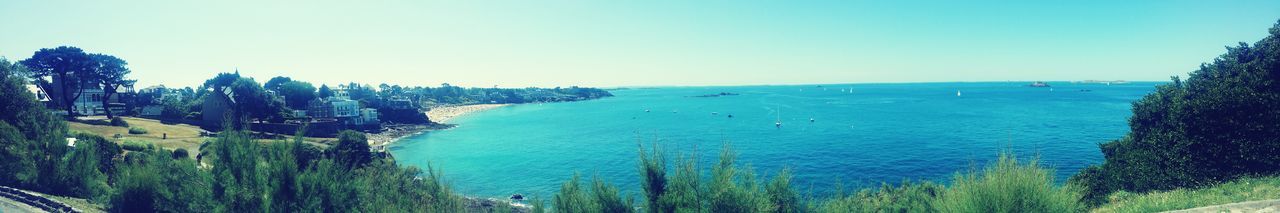 Panoramic view of sea against clear blue sky