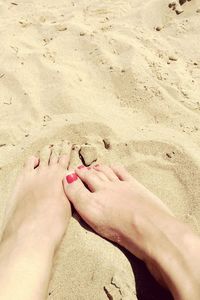 Low section of people relaxing on sand