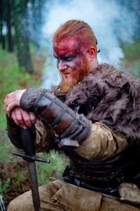 Portrait of young man holding camera