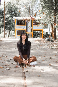 Portrait of young woman sitting outdoors