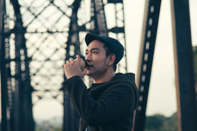 Portrait of young man smoking outdoors