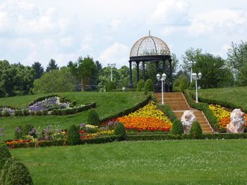 Scenic view of park against cloudy sky