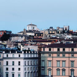 Buildings in city against clear sky