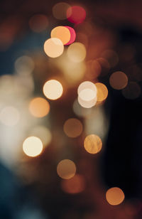 Defocused image of illuminated christmas lights at night