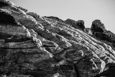 Low angle view of rock formation against clear sky