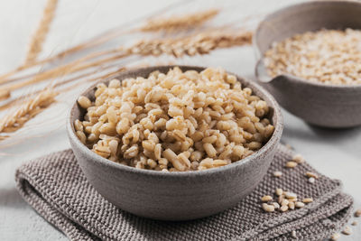 Bowl of cooked peeled barley grains porridge