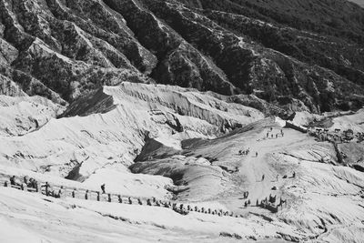 Distant view of people on dirt road at mt bromo