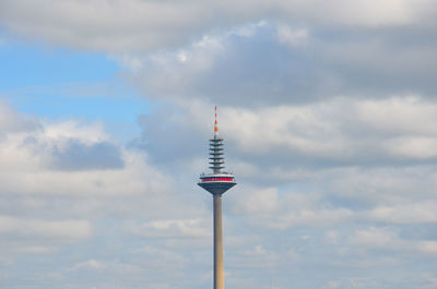 Low angle view of communications tower against sky
