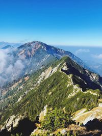 Scenic view of mountains against blue sky