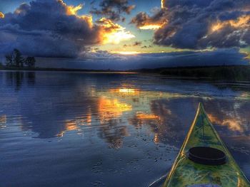 Reflection of clouds in sea at sunset