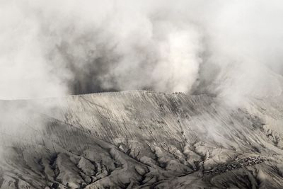 Smoke emitting from volcanic mountain against sky