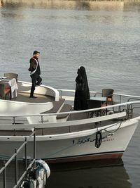 Man standing on boat in sea