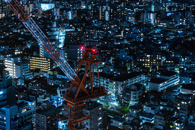 High angle view of illuminated buildings in city at night