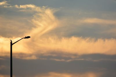 Low angle view of street light against sky during sunset