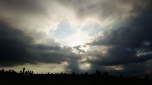 Scenic view of field against cloudy sky