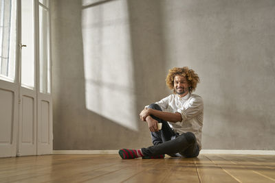 Smiling young man sitting in a room