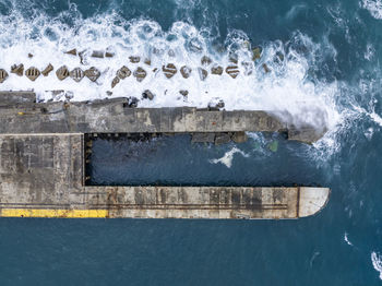 Bird's eye view of the harbour of stanley with a breakwater sea wall pier, tasmania, australia.