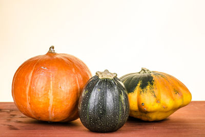 Close-up of pumpkins against white background