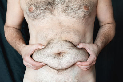 Midsection of man with hands