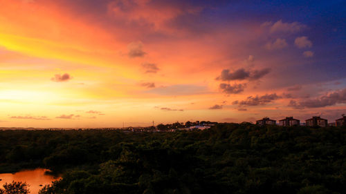 Scenic view of landscape against orange sky