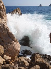 Scenic view of sea waves splashing on rocks