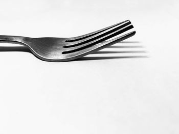 Close-up of fork on white background