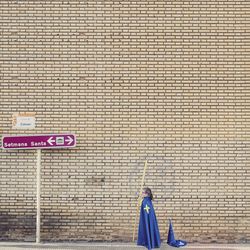 Man standing on brick wall