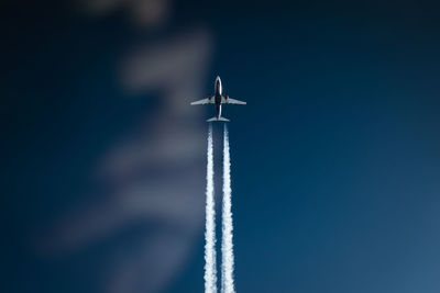 Low angle view of airplane against sky