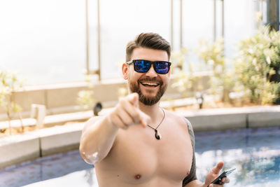 Portrait of handsome young man in swimming pool