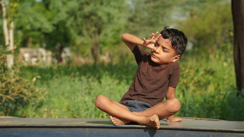 Kids doing yoga pose in the park outdoor. healthy life style concept.