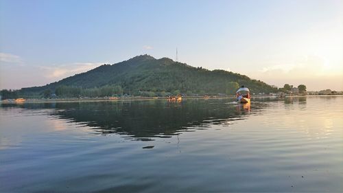 Reflection of man in lake against sky