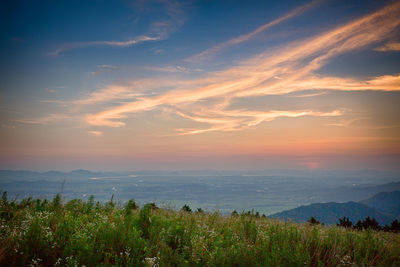 Scenic view of landscape against sky at sunset
