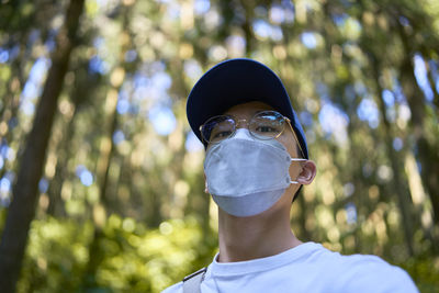 Low angle view of man wearing mask