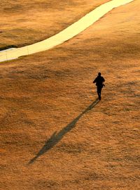 Full length of man running on field