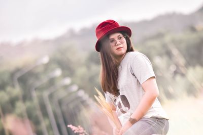 Portrait of smiling young woman wearing hat