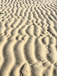 High angle view of footprints on sand at beach