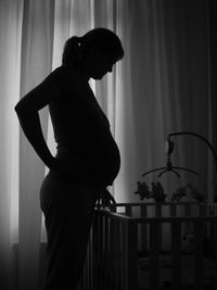 Silhouette pregnant woman at home