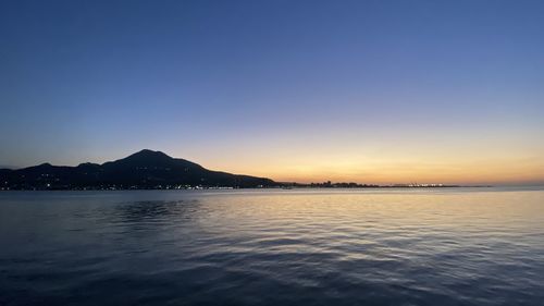 Scenic view of sea against clear sky at sunset