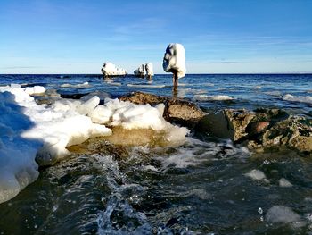 Ice floating on sea against sky