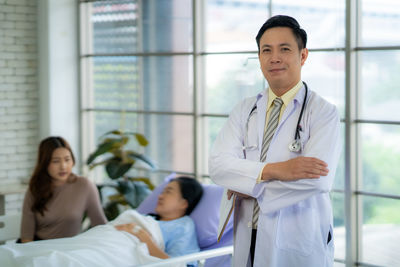 Portrait of smiling female doctor holding digital tablet