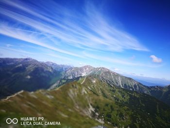 Scenic view of mountains against blue sky