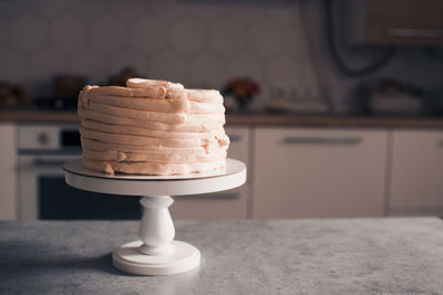 Tasty cake with cream cheese staying on kitchen table closeup. cooking at home. homemade.